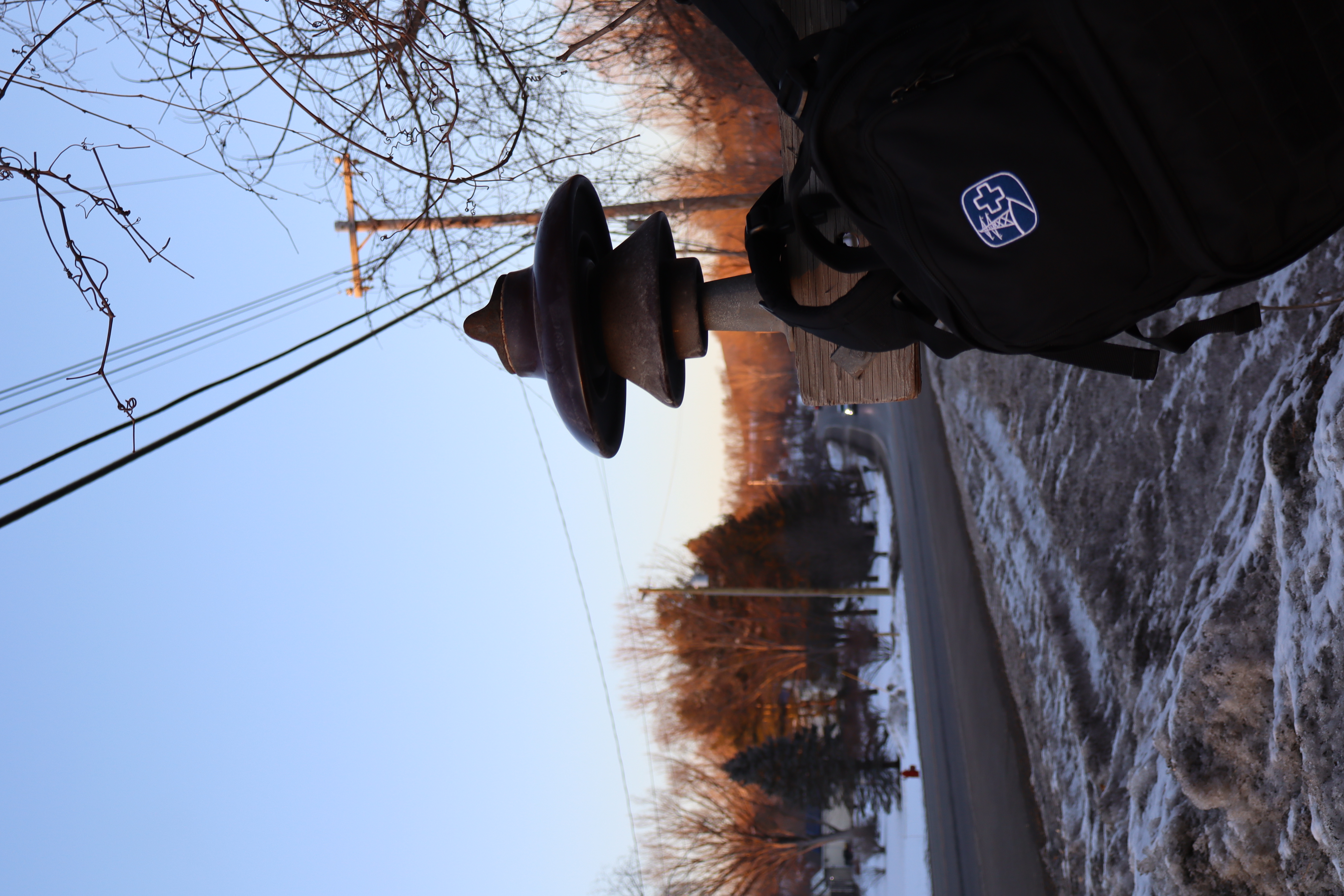 Goodmore Arc-Flash Trauma Response Backpack at the base of a utility pole at dusk